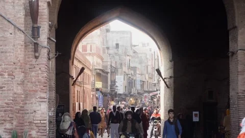 Pedestrians Passing Through Delhi Gate Lahore, Pakistan. 27 Jan 2026 Stock Footage 327794539