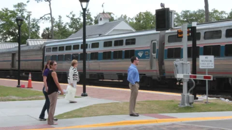 Pedestrians Patiently Wait for Train to Pass Stock Footage 37254096