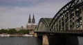 Pedestrians People Walk Hohenzollern Bridge Cologne Cathedral Skyline Sunny Day HD Footage
