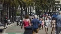Pedestrians slowly strolling in street, many tourists and locals in resort city HD Footage