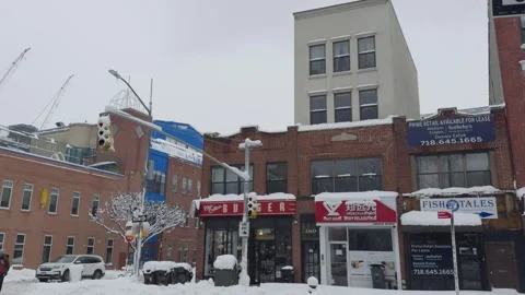 Pedestrians at Snowy Brooklyn Intersection, Construction Cranes, Blizzard Video stock 329888752