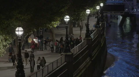 Pedestrians on South Bank walking along the Thames Stock Footage