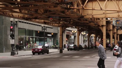 Pedestrians under the elevated train in Chicago, Illinois. Stock Footage 79698473