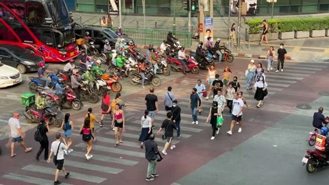 Pedestrians use the crosswalk in Asok intersection, Bangkok, Thailand 4K Stock Footage 235926622