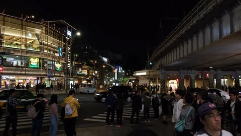 Pedestrians wait for the traffic light and cross the road in Tokyo, Japan. Stock Footage 120096351