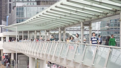 Pedestrians walking along the Central Elevated Walkway Stock Footage 109256967