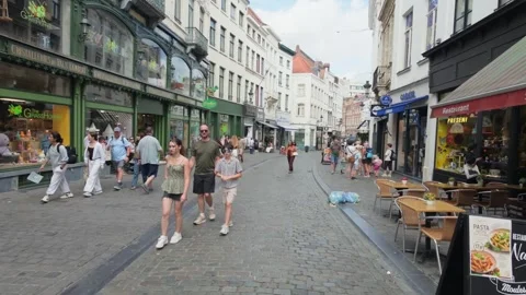 Pedestrians Walking Along Cobblestone Shopping Street Near Grand Place With Stockbeeldmateriaal 345303553