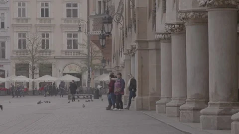Pedestrians Walking past Arched Arcade Columns in Square Stock Footage 342558963