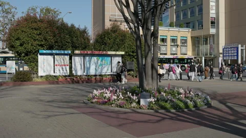 Pedestrians walking past transit maps in Yokohama Stock Footage 332608594