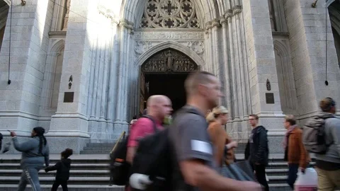 Pedestrians walking on the sidewalk of Saint Patrick Church Stock Footage 81444003