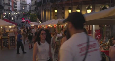 Pedestrians walking toward camera along Plaza Mayor at dusk Stockbeeldmateriaal 338338306