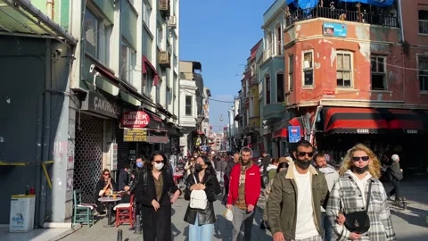 Pedestrians wearing face cover due to COVID-19, walk in Istanbul, Turkey 4K Stock Footage 166409902