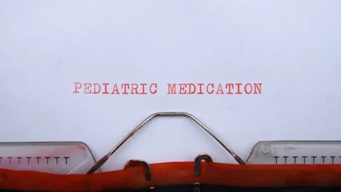 Pediatric medication - phrase printed on an old typewriter in red letters Video stock 128399611