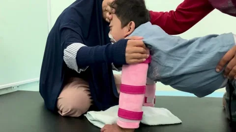 Pediatric Physical Therapy Session with Child with Motor Impairment Stock Footage 339566889