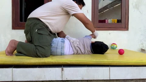 Pediatric Physiotherapy Session for Cerebral Palsy Rehabilitation Stock Footage 339394567