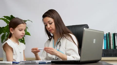Pediatrician doctor using thermometer to check child body temperature Stock Footage 238806598