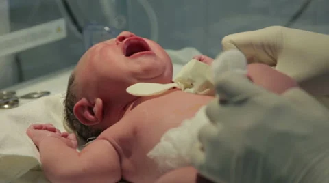 Pediatrician examining newborn child old 10 minutes, infant close up. Stock Footage