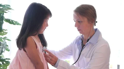 Pediatrician Running Checkup on Asian Child Stock Footage
