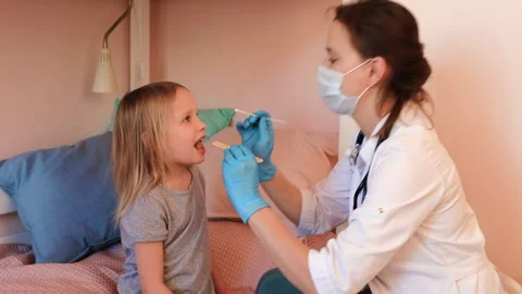 Pediatrician taking saliva test sample at home during coronavirus lockdown Stock Footage 146377903