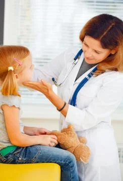 Pediatrician taking temperature with thermometer. Stock Photos