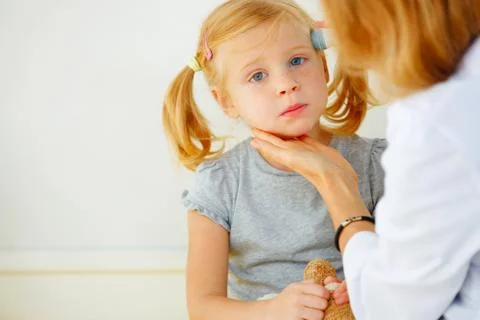 Pediatrician taking temperature with thermometer. Stock Photos