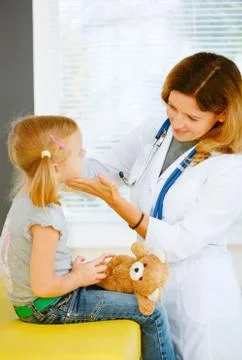 Pediatrician taking temperature with thermometer. Stock Photos