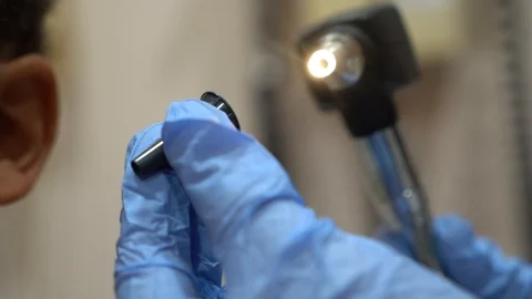 Pediatrition checking ears of young patient Stock Footage 107322014