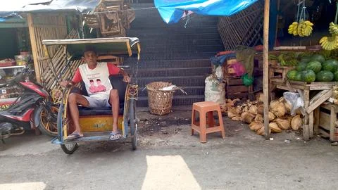 Pedicab drivers wait for customers to get on the Becak Foto stock