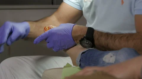 Pedicure cleansing and bandaging wound on injured toenail after pulled toe nail. Stock Footage 59679922