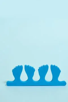 Pedicure kit. Finger separators on a blue background Stock Photos