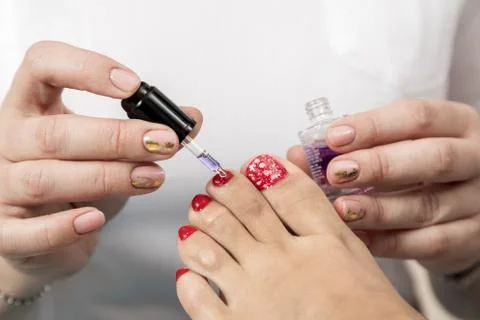 Pedicure Master does the procedure to the client Stock Photos
