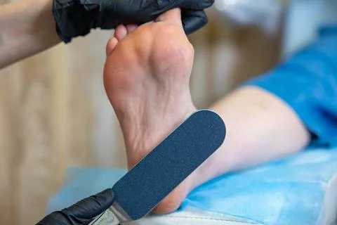 Pedicure master does procedure for legs. The master grinds the heel Stock Photos