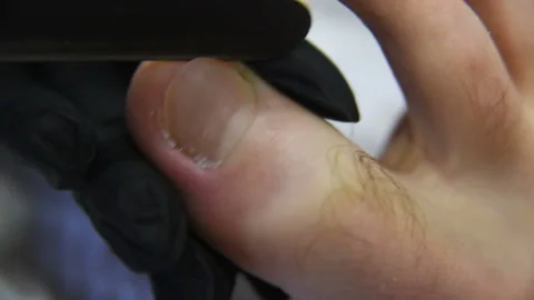 Pedicure master doing finger nail care customer men on spa salon background Stock-Footage 101439799