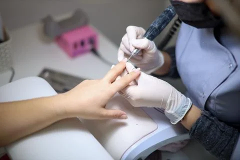 The pedicure master performs the cleaning of the claws of the feet Stock Photos