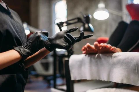 Pedicure master prepares for procedure with client Stock Photos