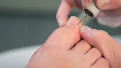 Pedicurist is making hardware pedicure using electricmachine in beauty salon. Stock Footage 159951551