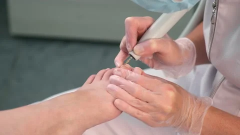 Pedicurist is making hardware pedicure using electricmachine in beauty salon. Stock Footage 169526203