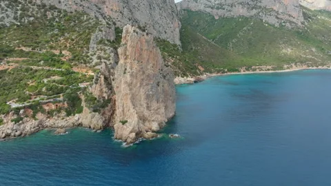 Pedra Longa Monolith emerging from the crystalline Sardinian sea Stock Footage 313292669