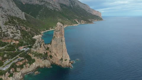 Pedra Longa Monolith emerging from the Sardinian sea Stock Footage 313292641
