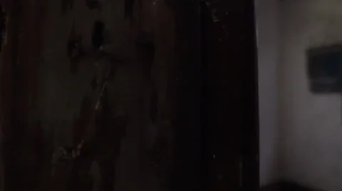 Peeking out behind interior wall in abandoned house Stock Footage 67809728