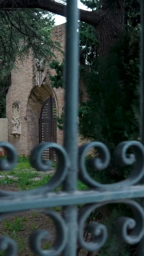Peeking through an old gate into a secret garden Stock Footage 327115187