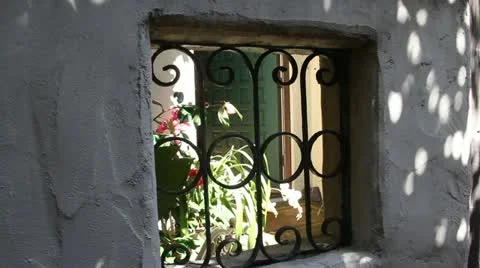 Peeking through old window to green door Stock Footage 21588046