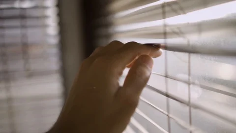 Peeking through plastic window blinds - looking outside from office or house Stock Footage 109164331