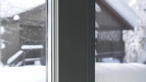 Peeking Through Window at Snow-Clad Pine and Rustic Mountain Home Stock Footage 252779594