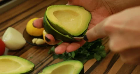 Peel an avocado with a spoon Stock Footage 244424405