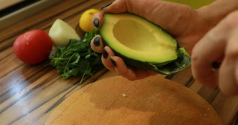 Peel an avocado with a spoon Stock Footage 244425822