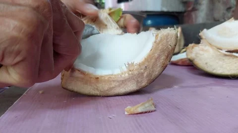Peel the coconut meat from the fruit Stock Footage 261165528
