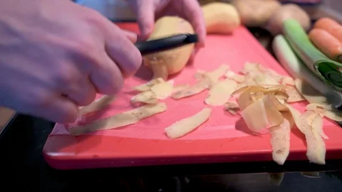 Peel the potato on a cutting board Stock Footage 124679858