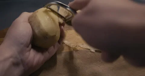 Peel a potato by hand Stock Footage 255841903