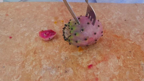Peel prickly pears red with fork and knife on white wooden table Stock-Footage 218775181
